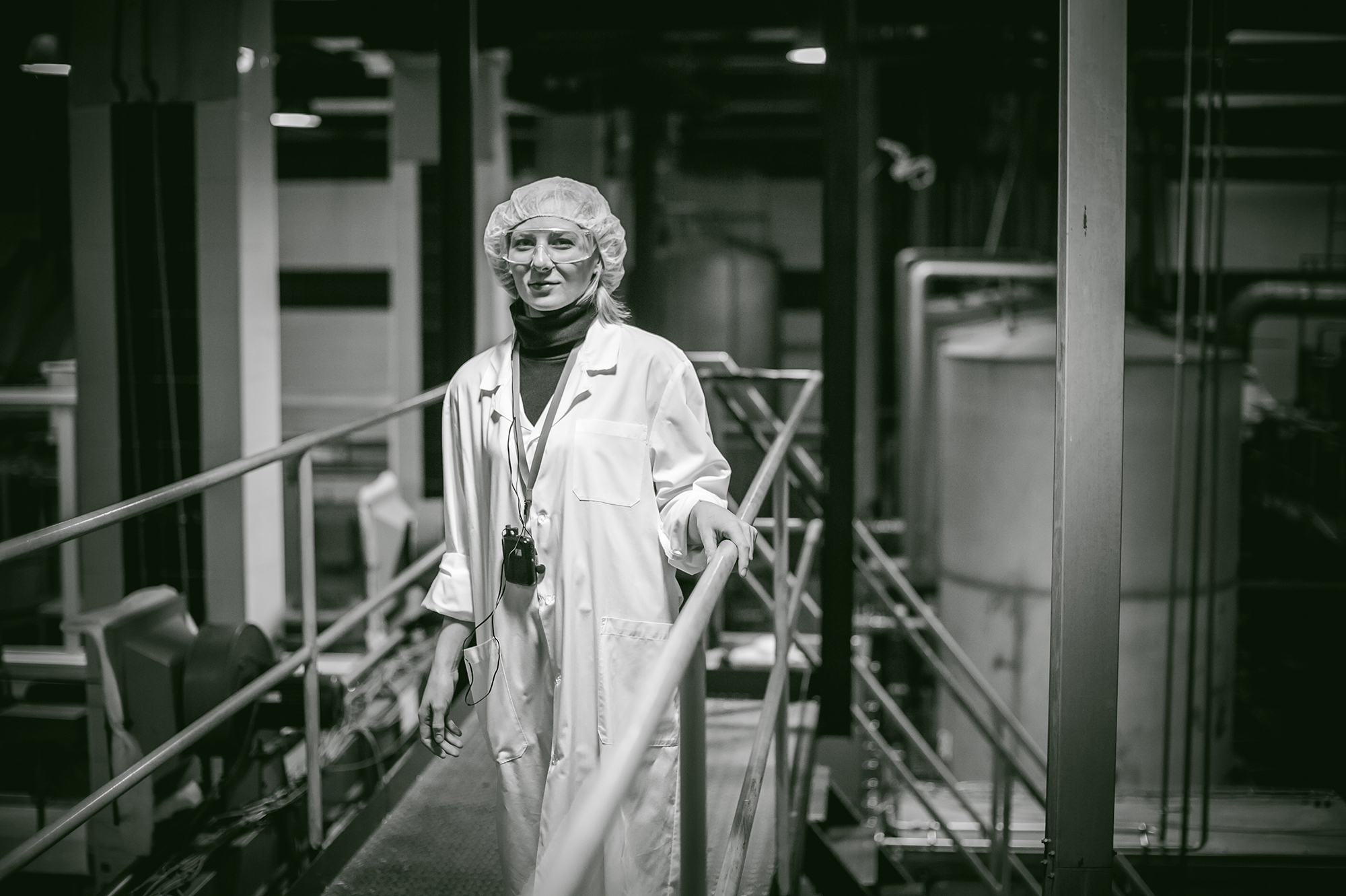 Female worker on the production line of beer factory. portrait o