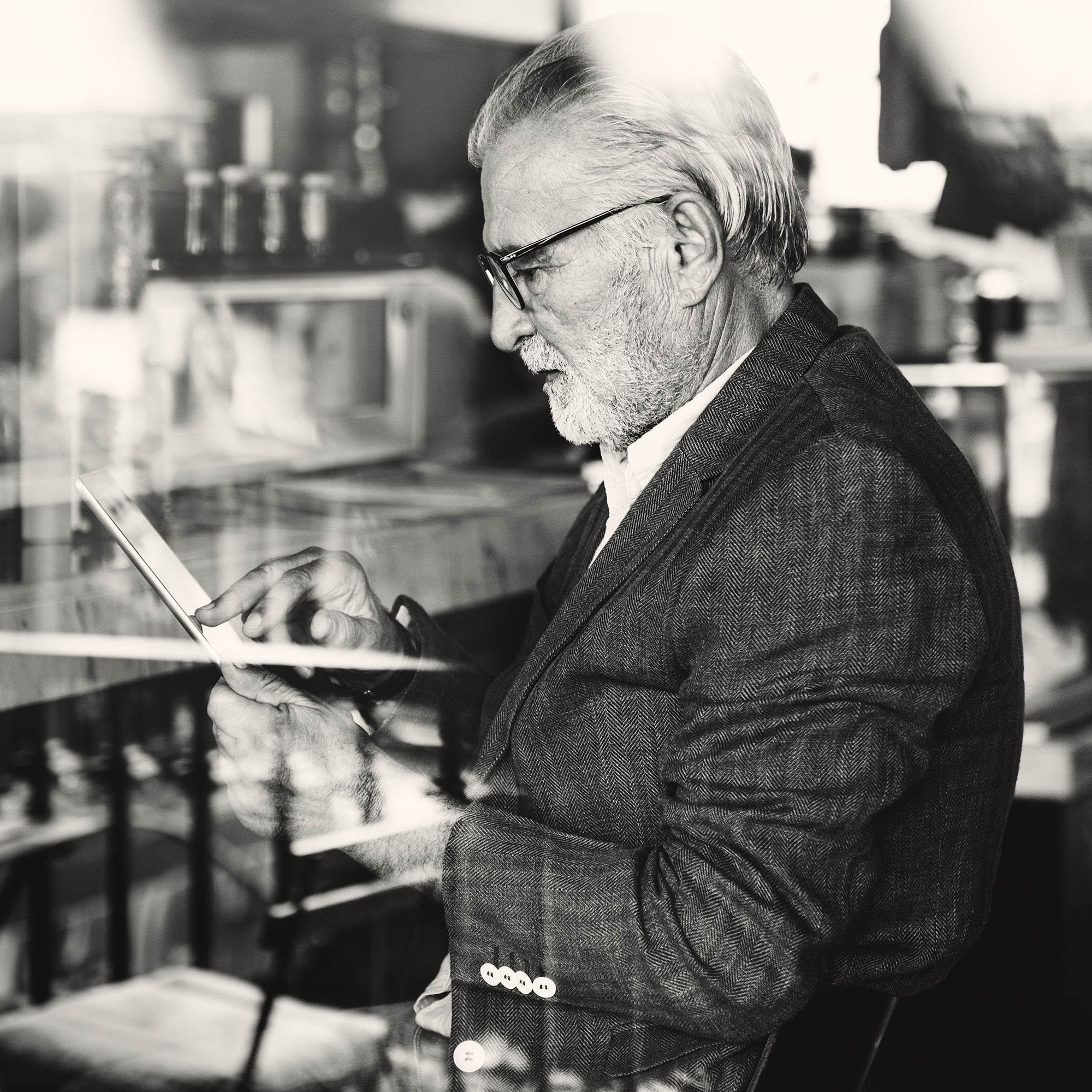 Elderly man is using digital tablet