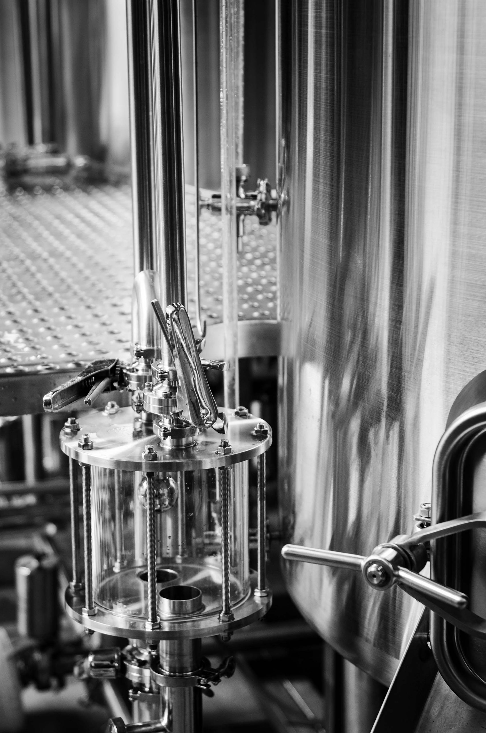 industrial beer brewing equipment detail in brewery interior